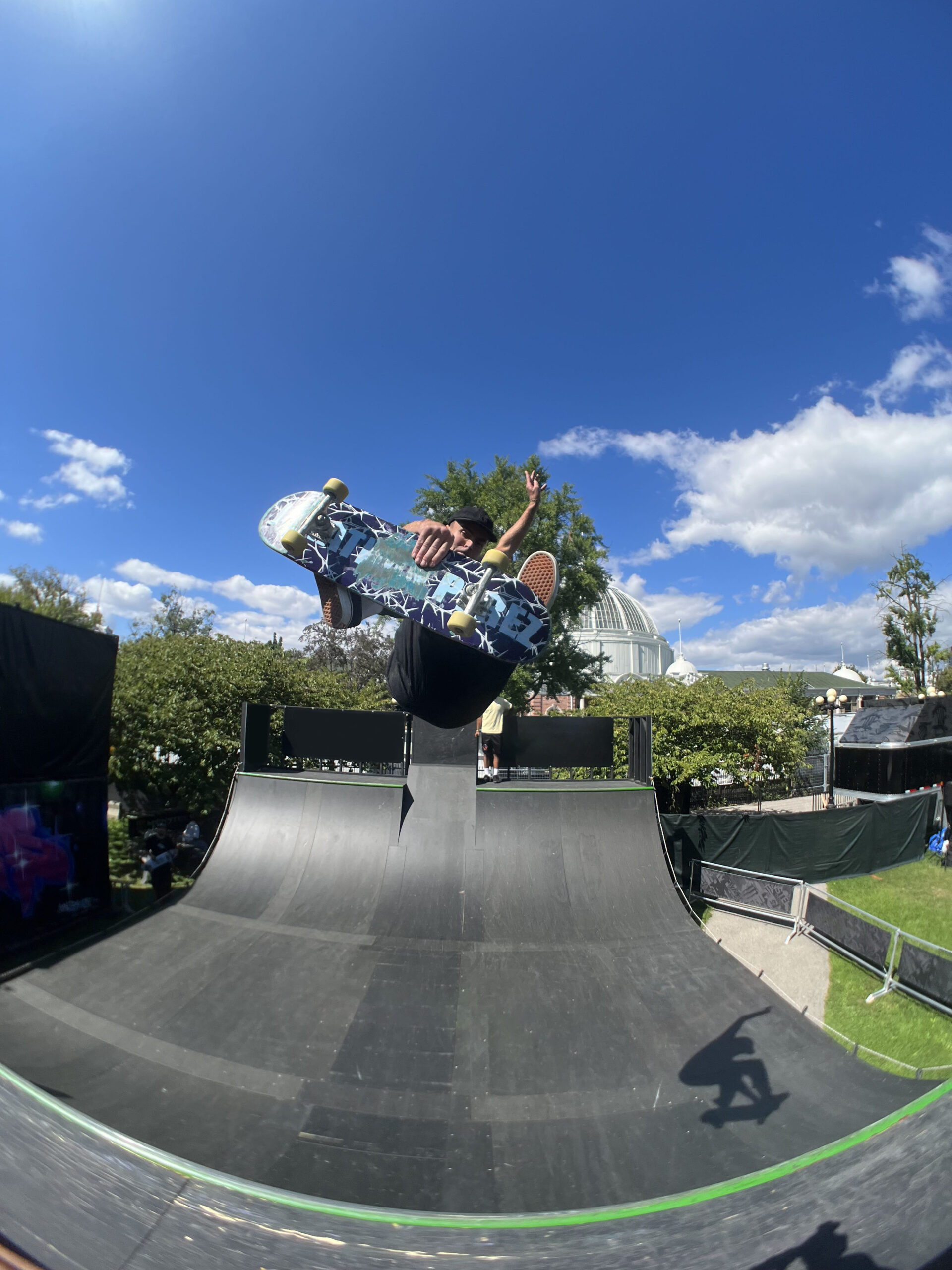 Man doing an air in a skateboard miniramp.